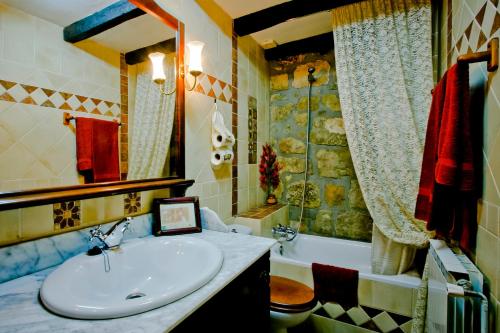 a bathroom with a sink and a bath tub at Masia Manonelles in Biosca