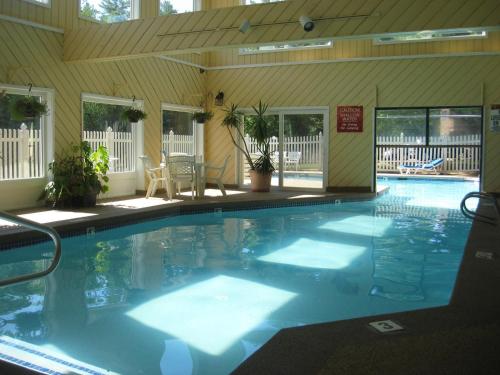 a large swimming pool in a house with at Cathedral Ledge Resort in North Conway