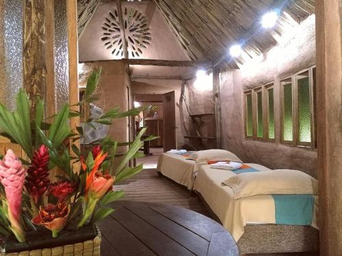 
a room with a bed, a table and a window at Eco Hotel Cosmogenesis in Cumaral
