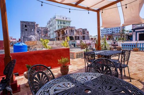 a patio with tables and chairs and a view of a city at Blanc Blue 1924 in Havana
