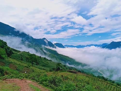 a view of a mountain valley with clouds at SaPa Farmer House in Sa Pa