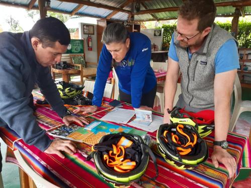 a group of three men standing around a table at Suymar Ecolodge Galapagos in Puerto Ayora