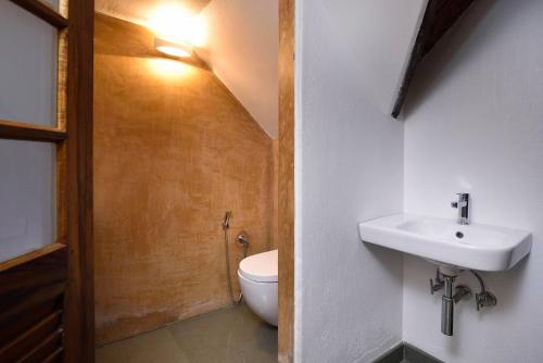 a bathroom with a sink and a toilet at StayVista at Shalom Villa with Pvt Pool & Alfresco Dining in Alleppey