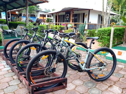 four bikes parked on a rack in front of a house at Suymar Ecolodge Galapagos in Puerto Ayora