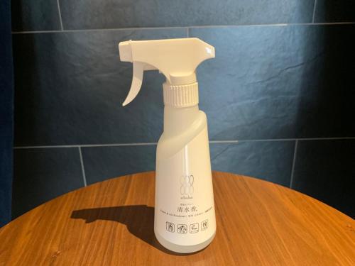 a white spray bottle sitting on top of a table at HOTEL STATE TENNOJI in Osaka