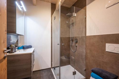 a bathroom with a shower and a sink at Chalet Alpenherz in Kirchberg in Tirol