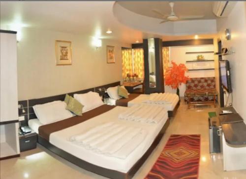 two large beds in a room with at Hotel Shree Vatika in Bhopal
