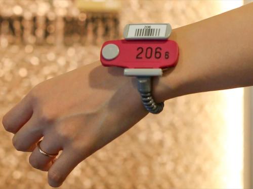 a person holding a smart watch on their wrist at LEO YU Capsule Hotel Nishifunabashi in Funabashi