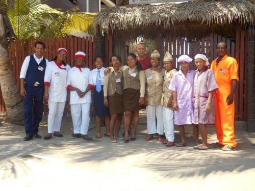 a group of people posing for a picture on the beach at hotel trecicogne in Morondava
