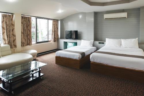 Postel nebo postele na pokoji v ubytování K.S.Pavilion Hotel