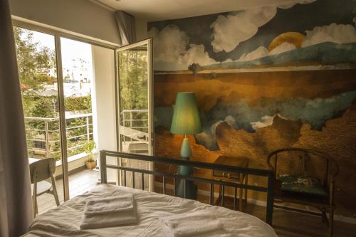 a bedroom with a painting on the wall at Vanilla Sky Boutique Hostel in Tirana