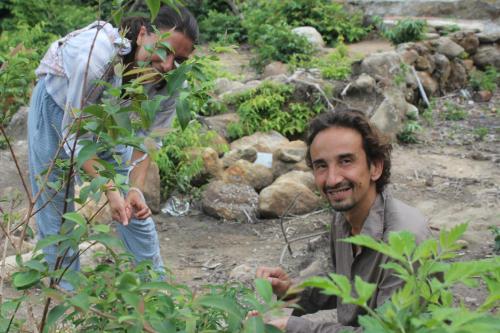 two people standing next to a man in a garden at Cham Island Smiles Homestay in Tân Hiệp