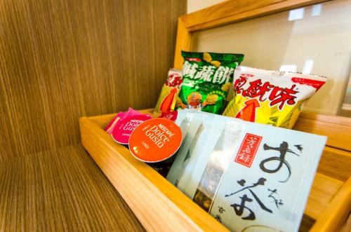 a wooden drawer filled with different types of snacks at Butchard Villas in Yuchi