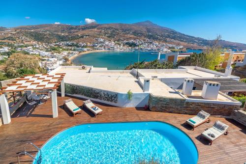 a pool on a deck with a view of the ocean at Belvedere Andros in Batsi