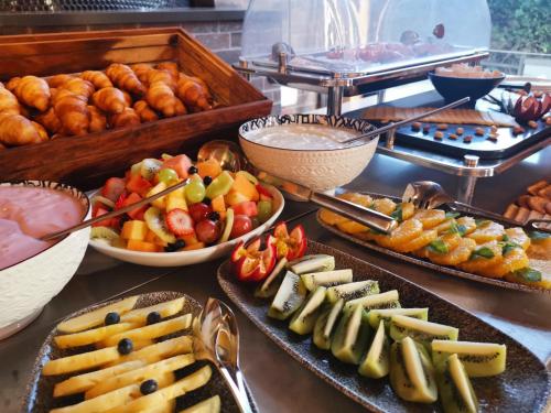a buffet line with different types of food and pastries at aha The Rex Hotel in Knysna