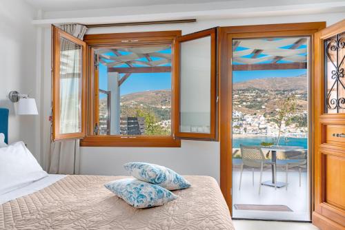 um quarto com uma cama e vista para o oceano em Belvedere Andros em Batsi