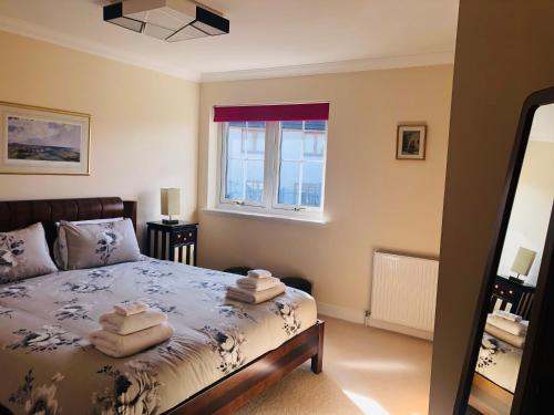 a bedroom with a bed with towels on it at Taigh d'Luxe in Inverness