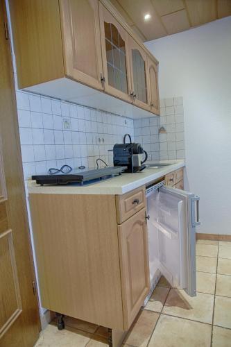 a kitchen with a sink and a stove top oven at Landhaus Göddertzhof in Erkelenz
