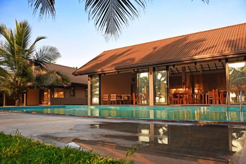 a resort with a swimming pool next to a building at Melheim Beach Kalpitiya in Kalpitiya