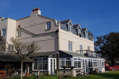 a large white building with a lot of windows at Great Trethew Manor Hotel & Self Catering Lodges in Liskeard
