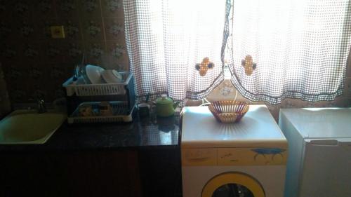 a laundry room with a window and a washing machine at Colibri Home in Kutaisi