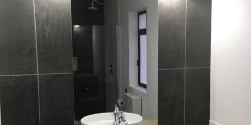 a bathroom with a sink and a shower with a mirror at Hayburg House in Robertson