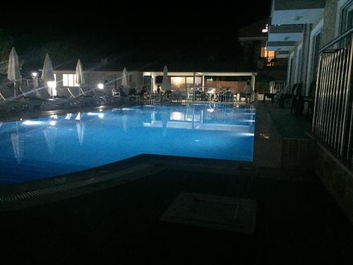 a large swimming pool at night with lights at Vespera hotel in Dalyan