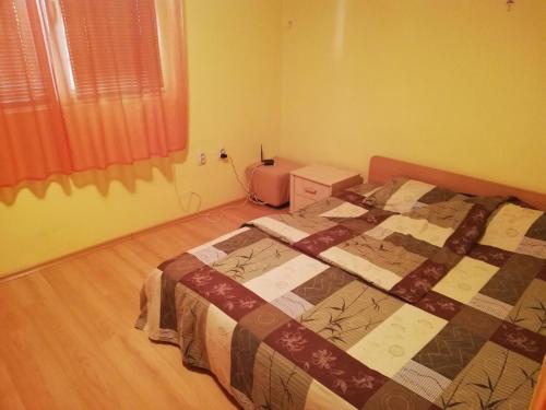 a bedroom with a bed with a quilt on it at Лукс апартамент in Stara Zagora