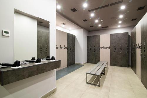 a locker room with a bench and a row of lockers at Ramada Hotel & Suites by Wyndham Yerevan in Yerevan