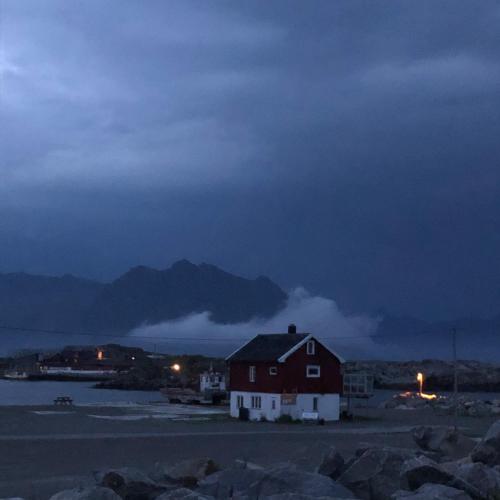 a house on the shore of a body of water at Laukvik Suites in Laukvik