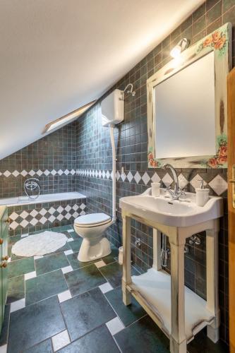 a bathroom with a sink and a toilet and a mirror at Villa Bunischa in Selca