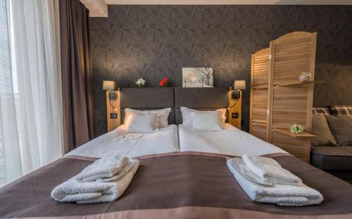 Ένα ή περισσότερα κρεβάτια σε δωμάτιο στο Powderinn • Gudauri