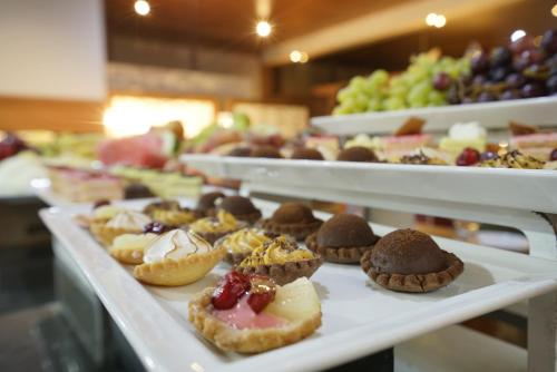 a row of trays filled with different types of pastries at AZ Hôtels Kouba in Alger