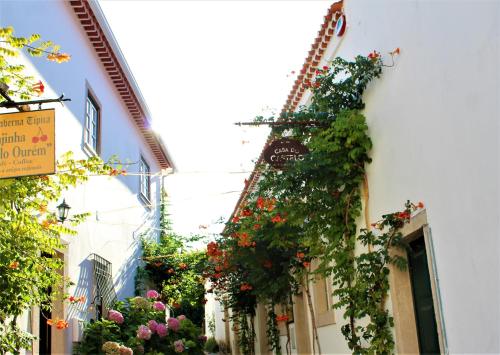 a street with flowers on the side of a building at Casa do Castelo Ourém in Ourém