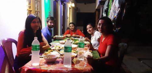 a group of people sitting around a table eating food at Marari Nadiya in Mararikulam
