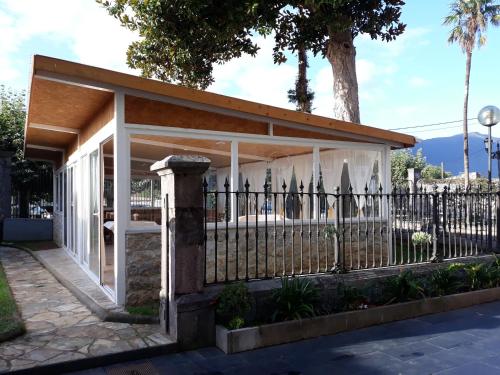 a pavilion with a fence and a tree at Hotel Palacio de Garaña in Garaña