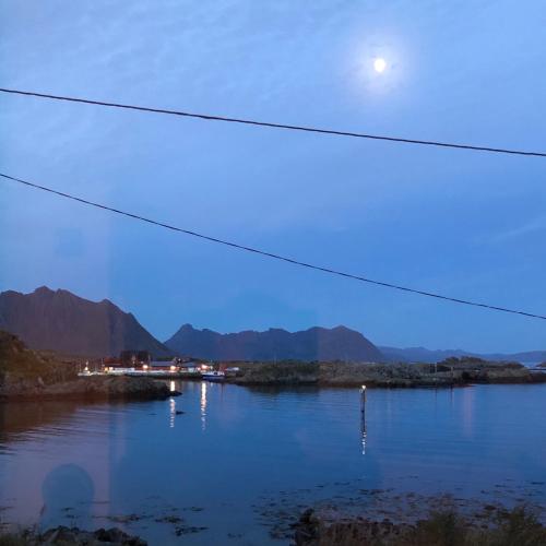 a view of a river with the moon in the sky at Laukvik Suites in Laukvik