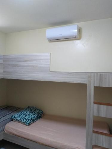 a bedroom with bunk beds with a light on the wall at Winterville Flats Gravatá in Gravatá