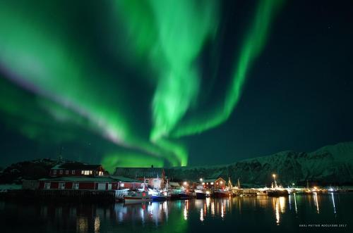 an image of the aurora in the sky over a harbor at Laukvik Suites in Laukvik
