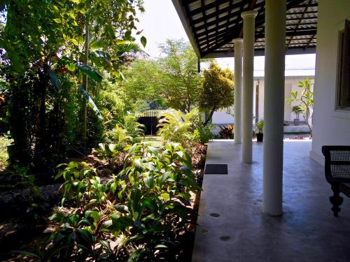 a garden with plants and a walkway in a building at South House-Weligama in Weligama