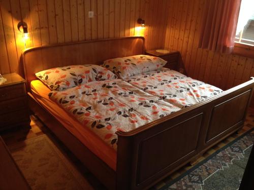 a bedroom with a bed with a flower comforter at bella Romantica in Brunig