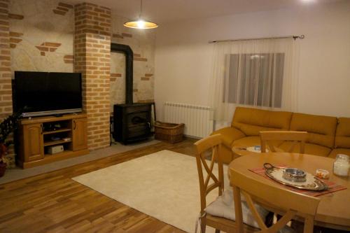 a living room with a couch and a table at Mountain house Vilina rosa in Kolašin