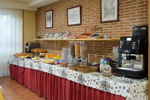 
a buffet table with plates of food on it at Hotel Corregidor in Segovia
