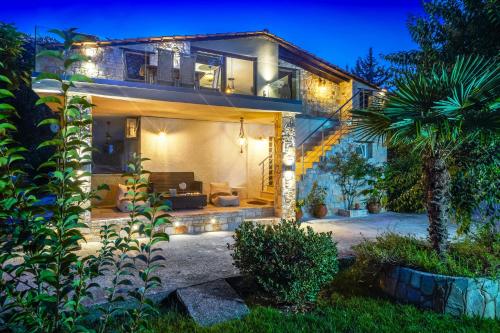 a house with a living room and a patio at Natura Bungalows-Villa in Limenas