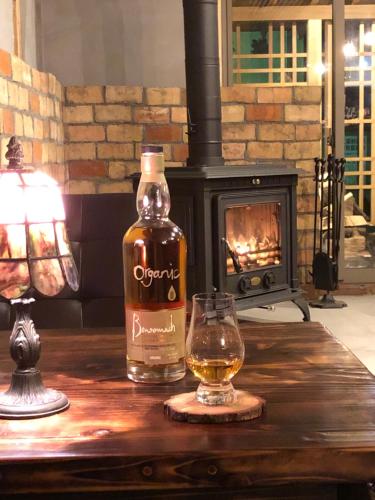 a bottle of cognac and a glass on a table at yuzaka - natural & sustainable inn - in Kazuno