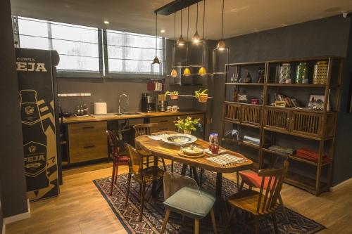 a kitchen with a table and chairs in a room at Vanilla Sky Boutique Hostel in Tirana