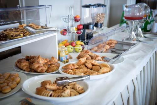 bufet z różnymi rodzajami wypieków i chleba w obiekcie Hotel Ambassador w mieście Marotta