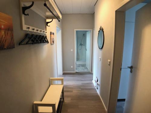 a hallway with a table and a mirror on the wall at Sanierte 2-Zimmer Wohnung in strandnähe in Kiel