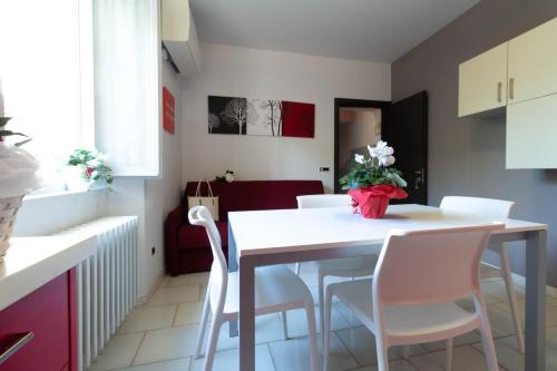 a kitchen and dining room with a white table and chairs at Le Casette Di Osvaldo in Lecco