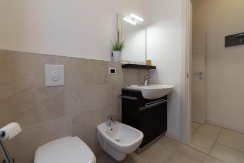 a bathroom with a toilet and a sink at Le Casette Di Osvaldo in Lecco